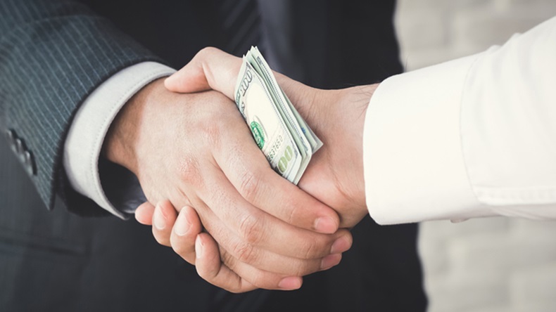Businessmen making handshake with money in hands - bribery, corruption and venality concepts - Image 