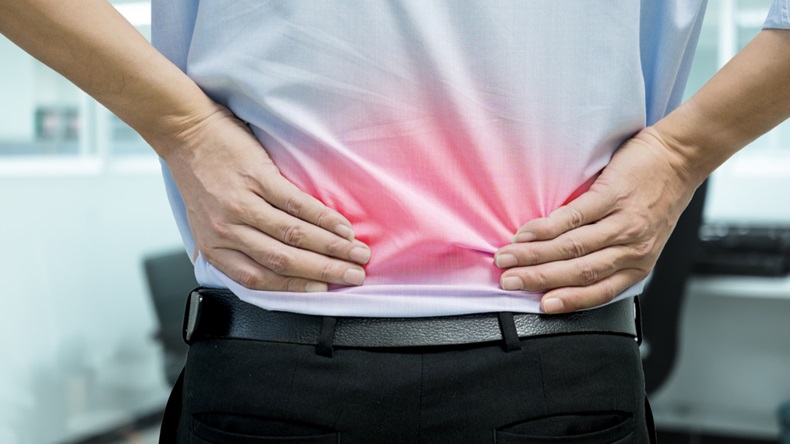 A man in blue shirt feeling pain on his back. Office syndrome. Back pain from work. Herniated nucleus pulposus. spine pain. spinal degeneration. - Image 