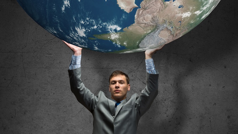 Young businessman holding Earth planet high above head. Elements of this image are furnished by NASA - Image 