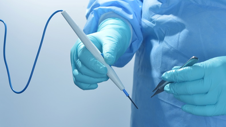 Doctor prepares to use electrocautery device during surgery.