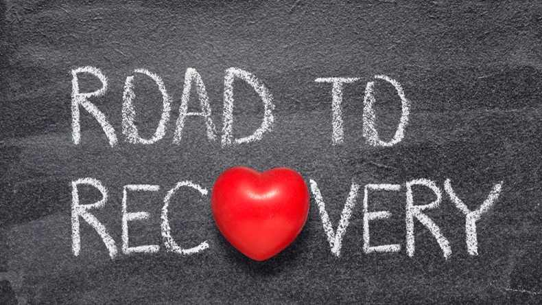 road to recovery phrase written on chalkboard with red heart symbol instead of O