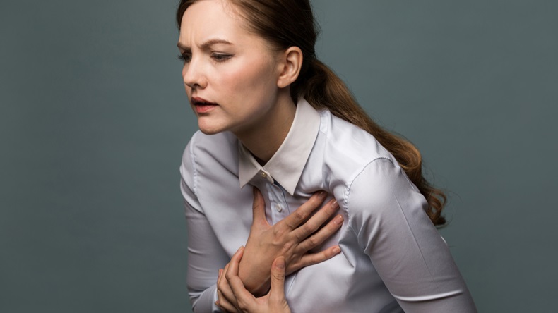 Young woman having heart ache.