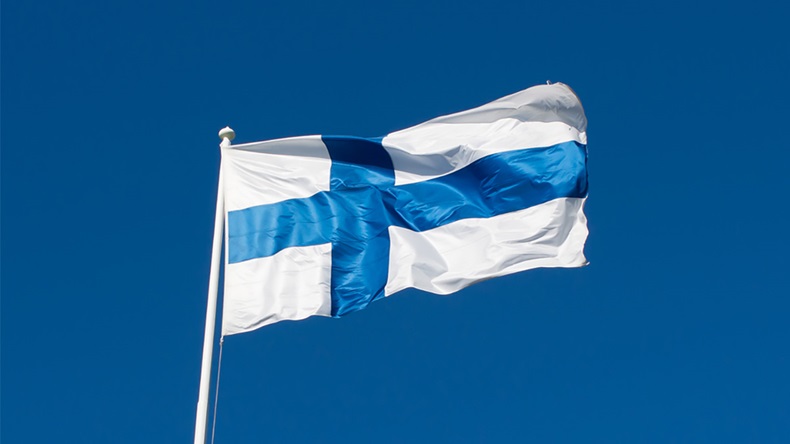 Flag of Finland flies against a blue sky