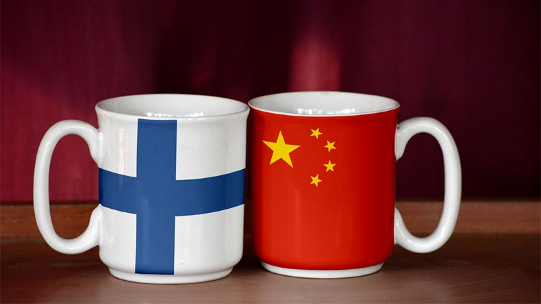 China and Finland flag on two cups with blurry background - Image 