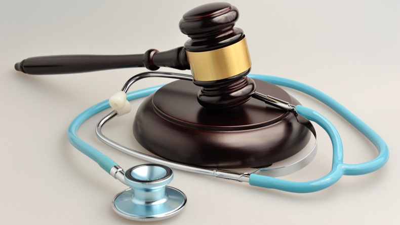 Stethoscope with judge gavel on gray background - Image 