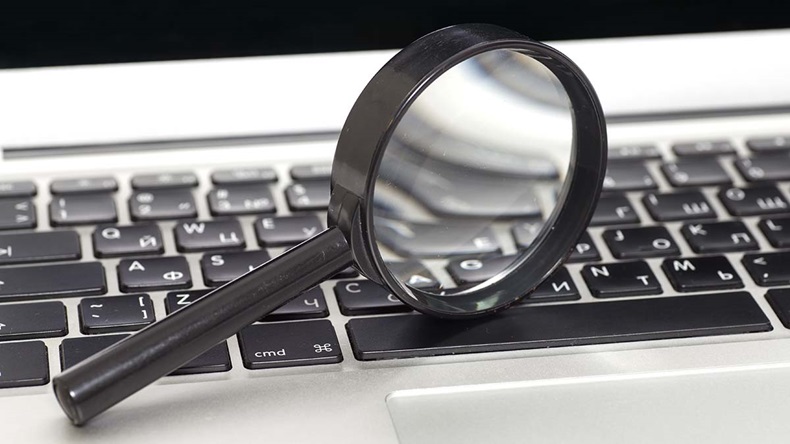Laptop With Magnifying Glass.