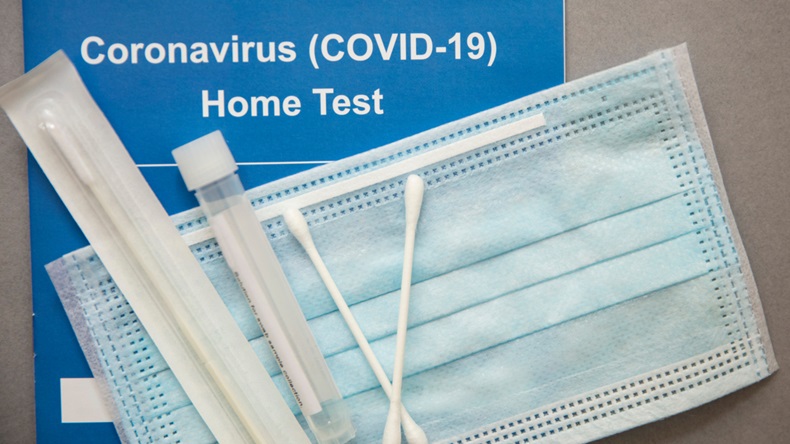 A take-home COVID-19 test kit and face mask