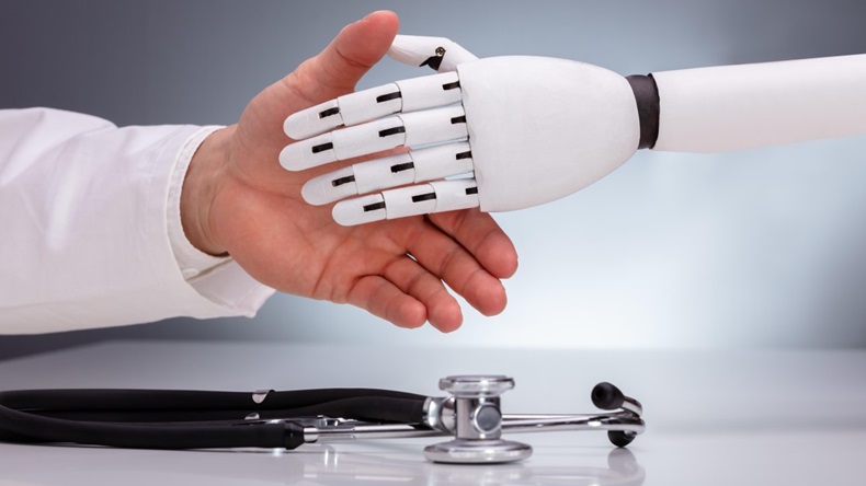 Doctor and robot shaking hands over stethoscope