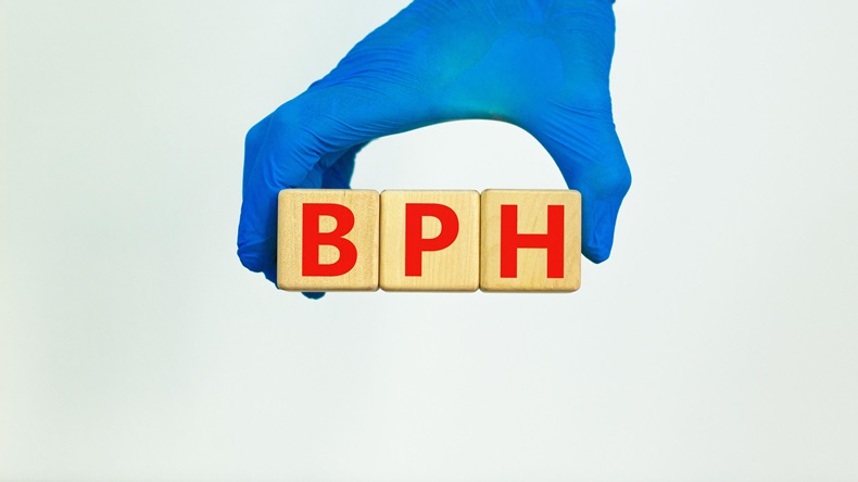Doctor holds wooden blocks with the word 'BPH'. 