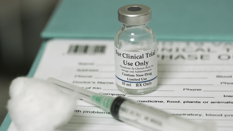 drug bottle on a trial form with a syringe