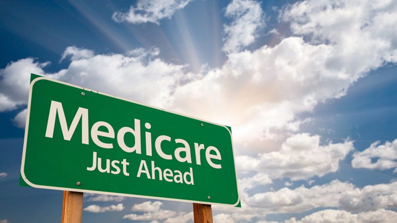 Green road sign reading "Medicare Just Ahead" 