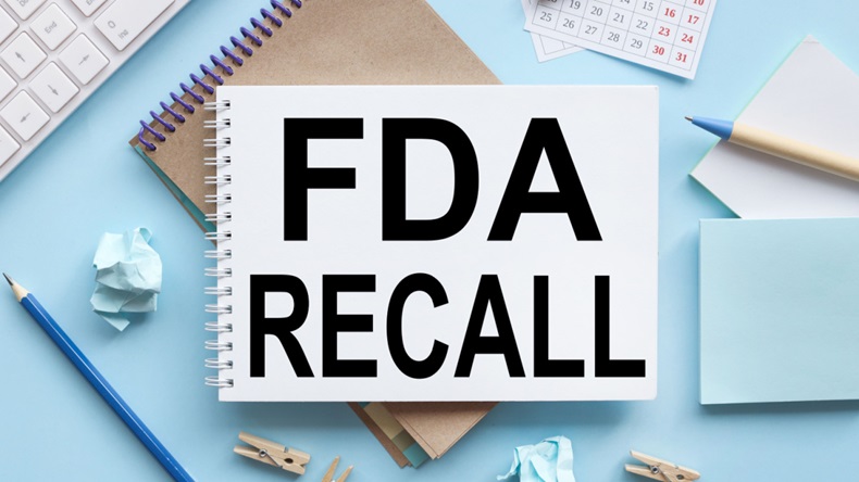 FDA recall text on white notepad paper on blue background.