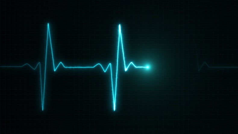 Blue electrocardiogram rhythm against black background